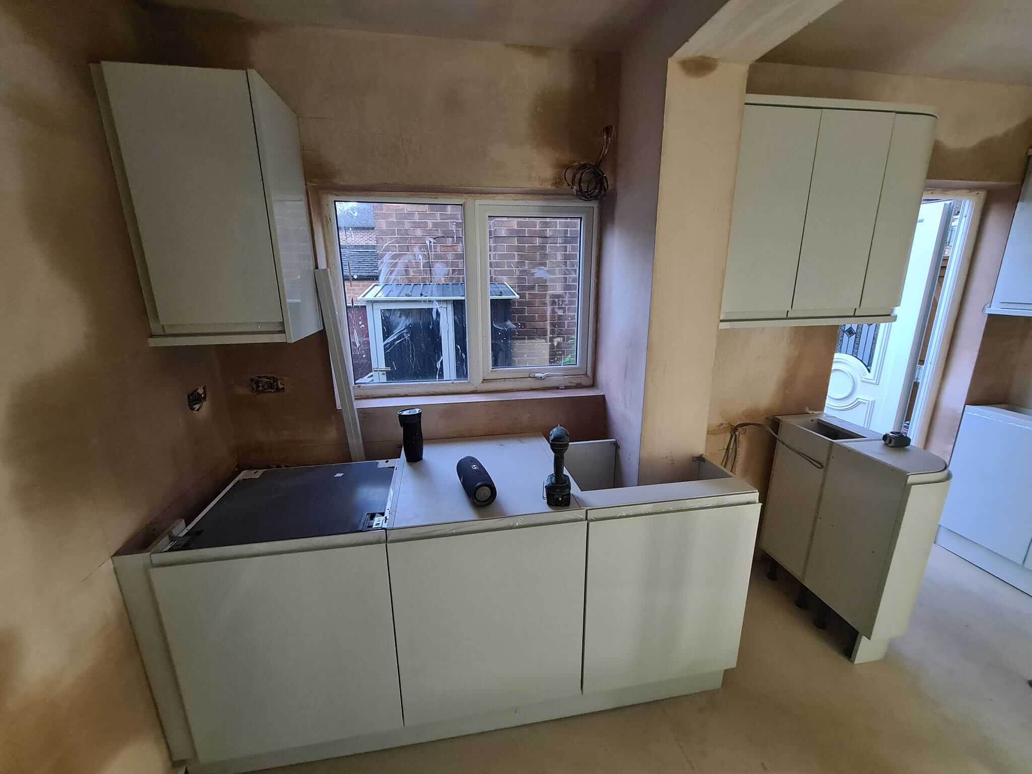 Kitchen project: Compact kitchen setup with sleek white cabinets