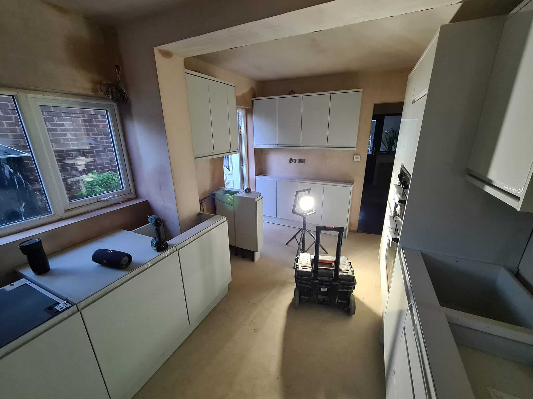 Kitchen project: Compact kitchen setup with sleek white cabinets