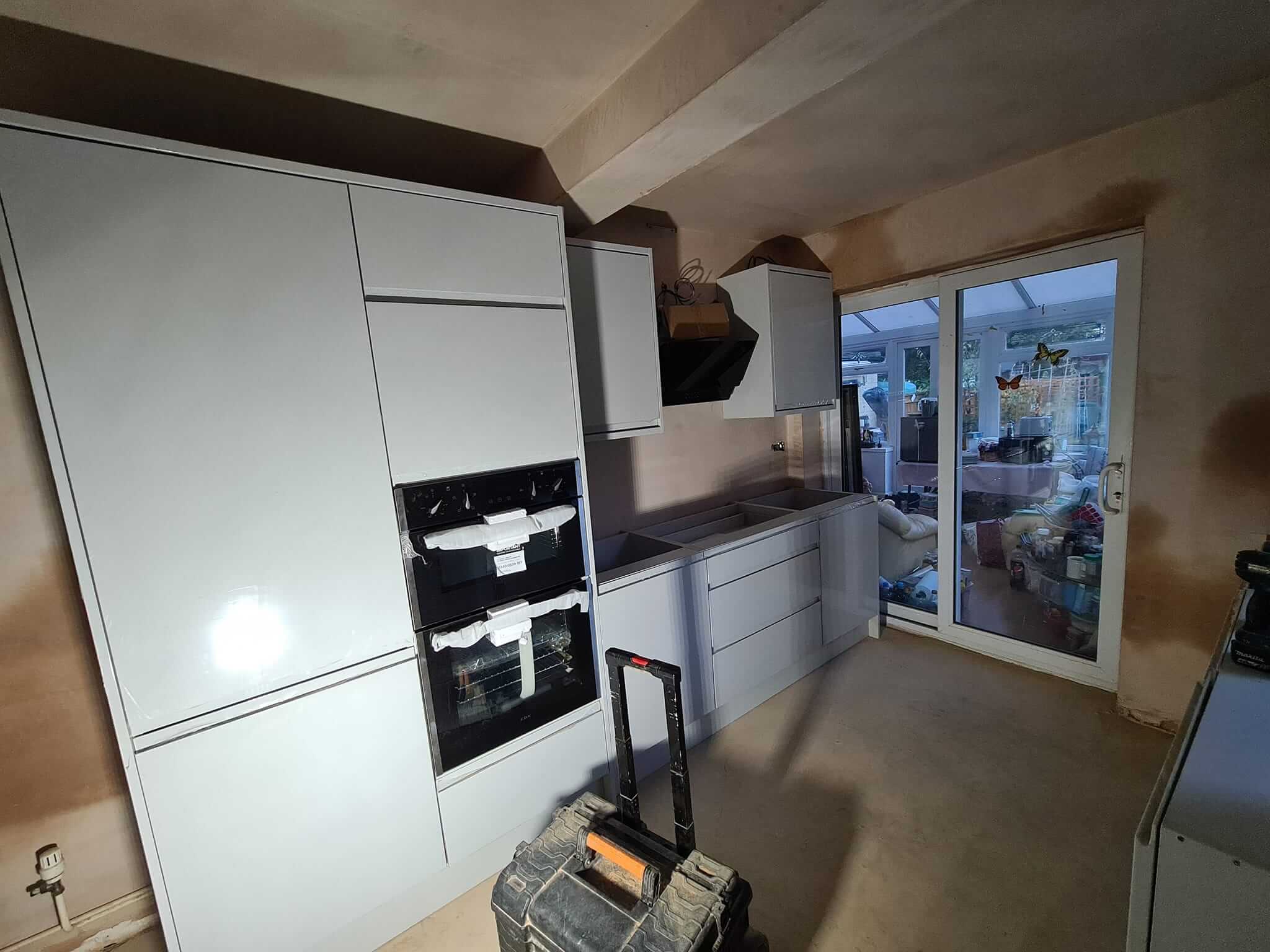 Kitchen project: Compact kitchen setup with sleek white cabinets